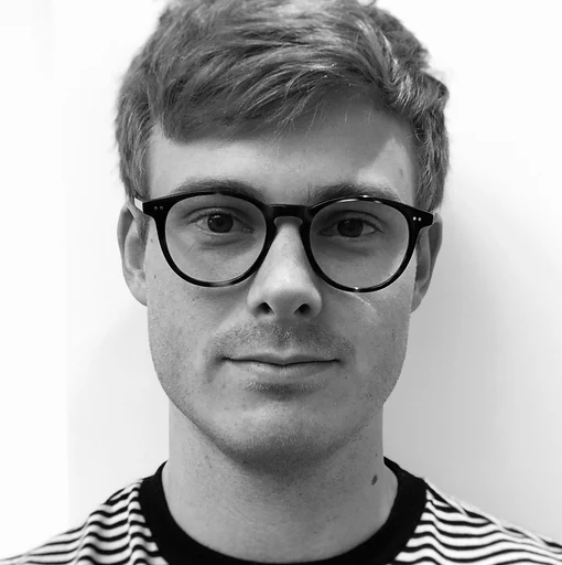 A man wearing glasses and a striped shirt.