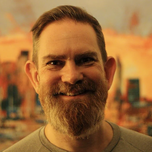 A close up of a person with a beard.